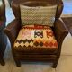 Brown cowhide armchair with a reversible seat cushion in KELIM.