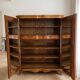 Antique Louis XV style wardrobe with curved wooden doors.