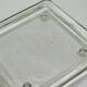 Vintage square serving tray in pale green tinted transparent glass with raised feet.
