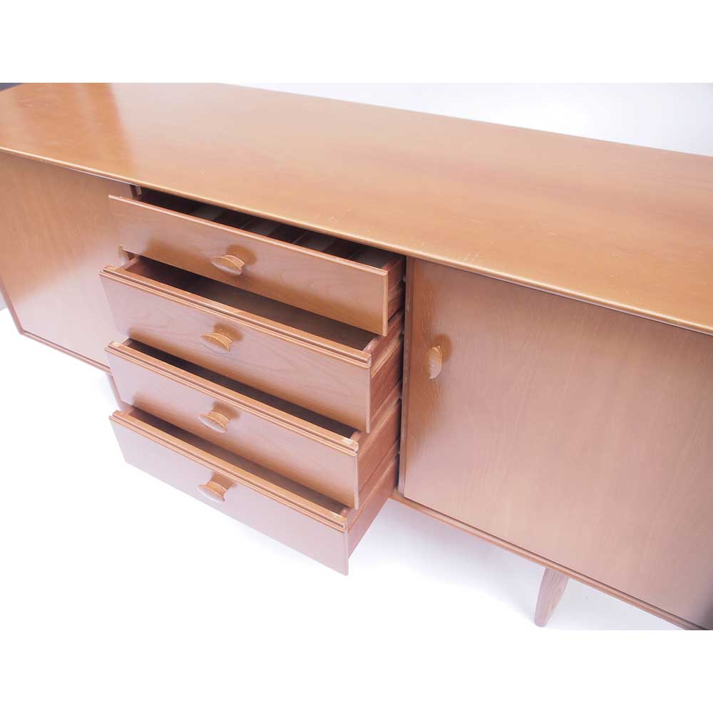 Vintage Scandinavian sideboard with an overflowing top.