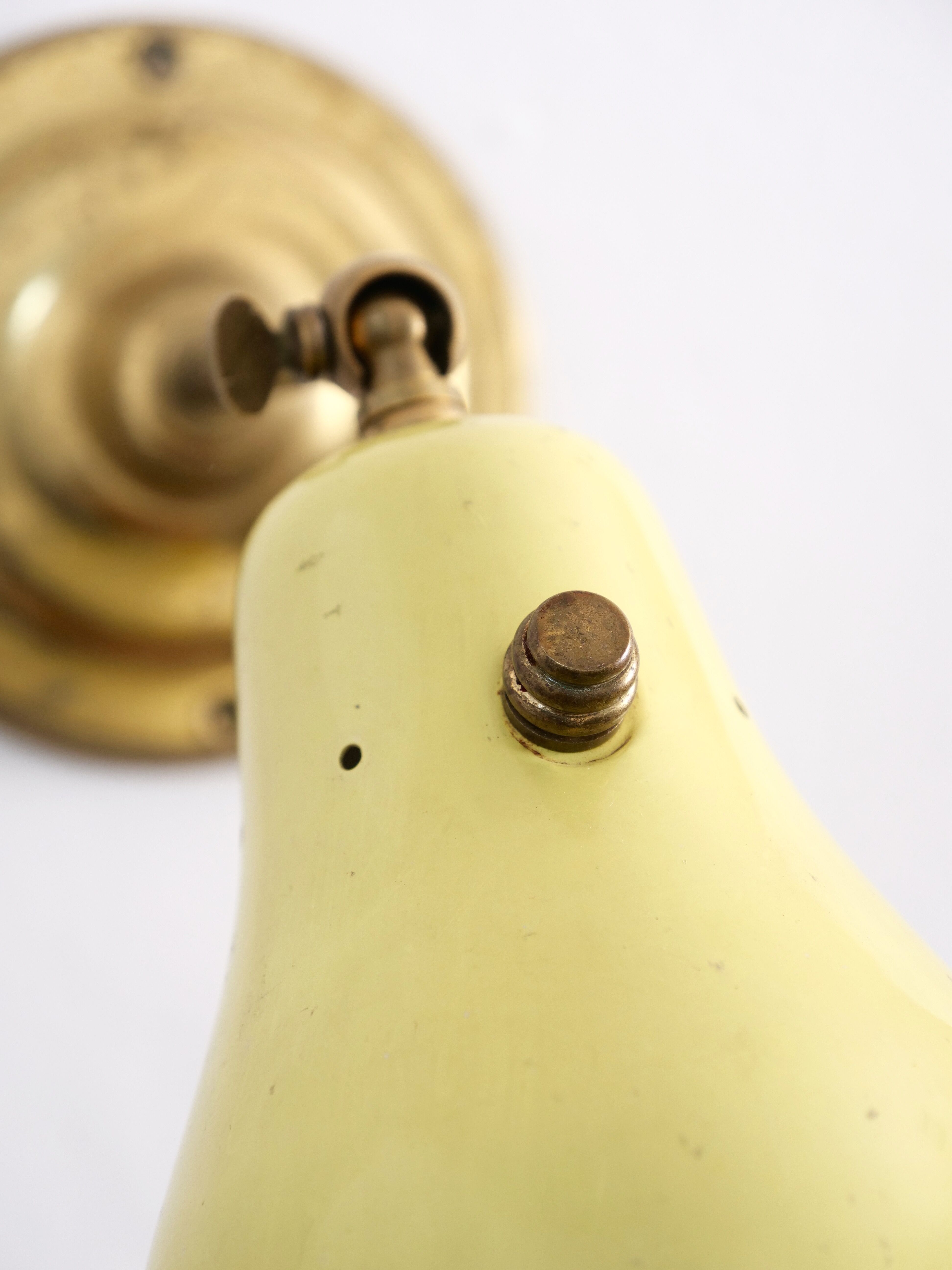 Wall lamp inlaiton and pale yellow lacquered metal