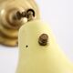Wall lamp inlaiton and pale yellow lacquered metal