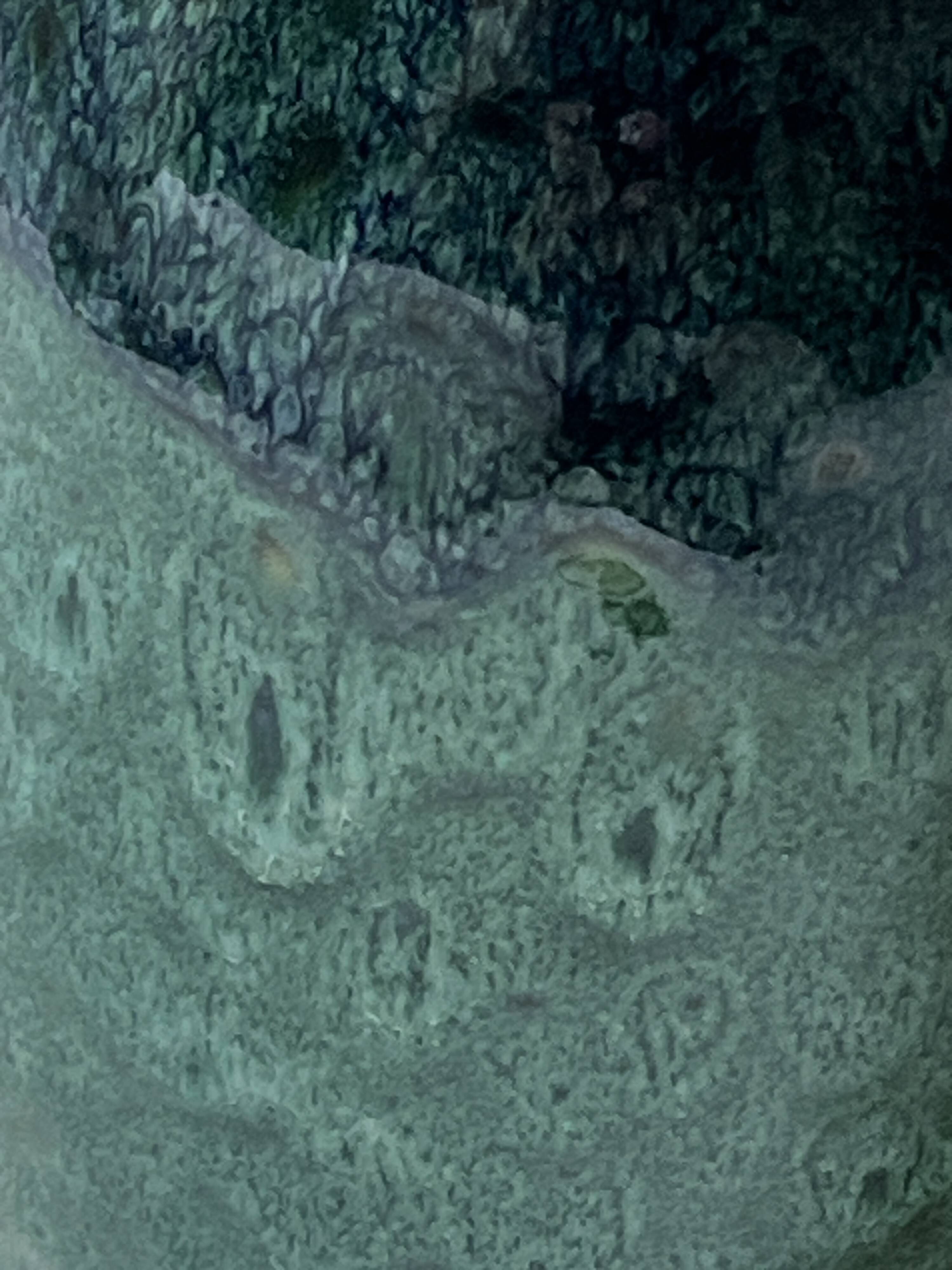 Ceramic vase with a glazed blue/green finish.