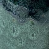 Ceramic vase with a glazed blue/green finish.