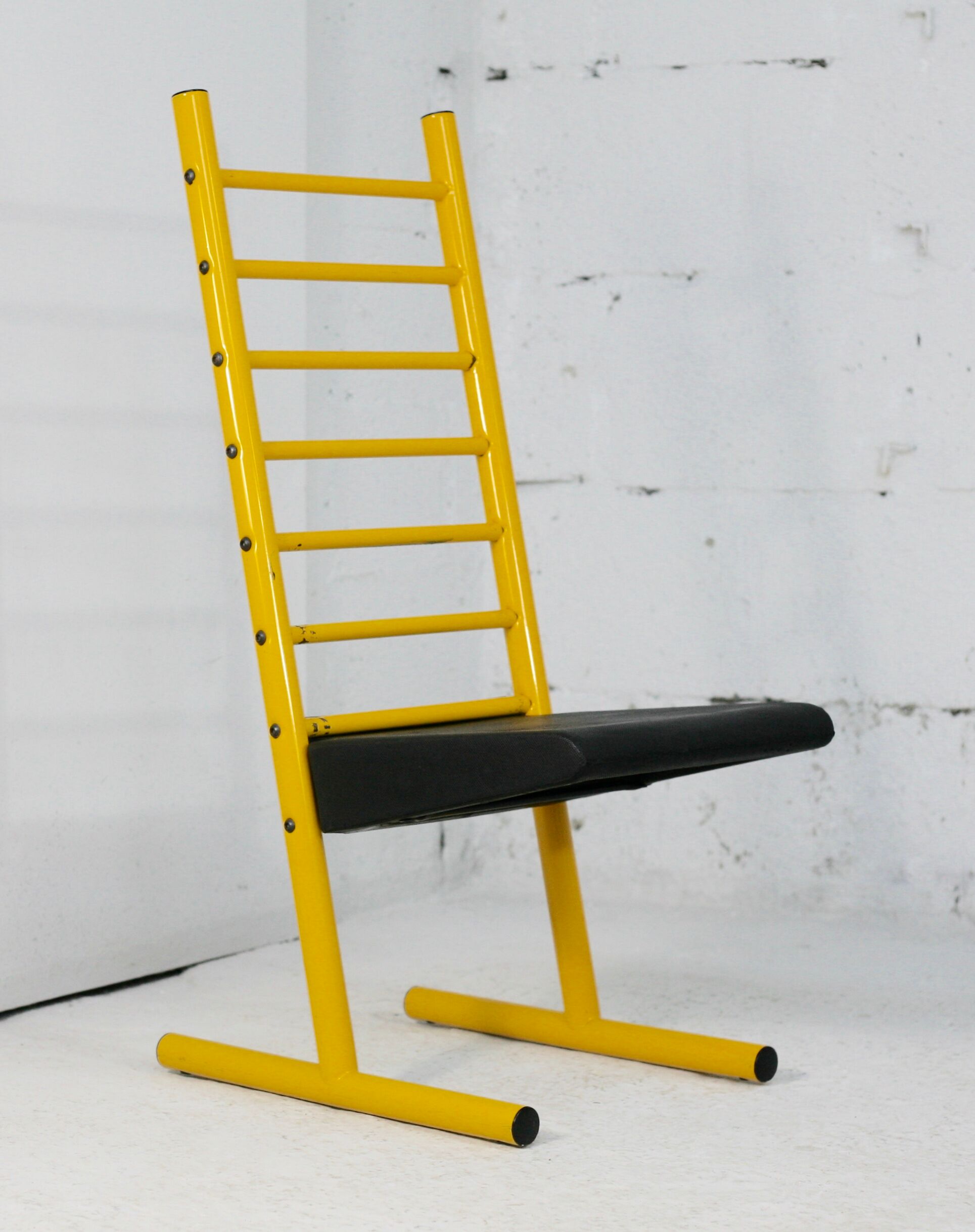 Adjustable seat chair. Circa 1980. Italy. Yellow lacquered steel.
