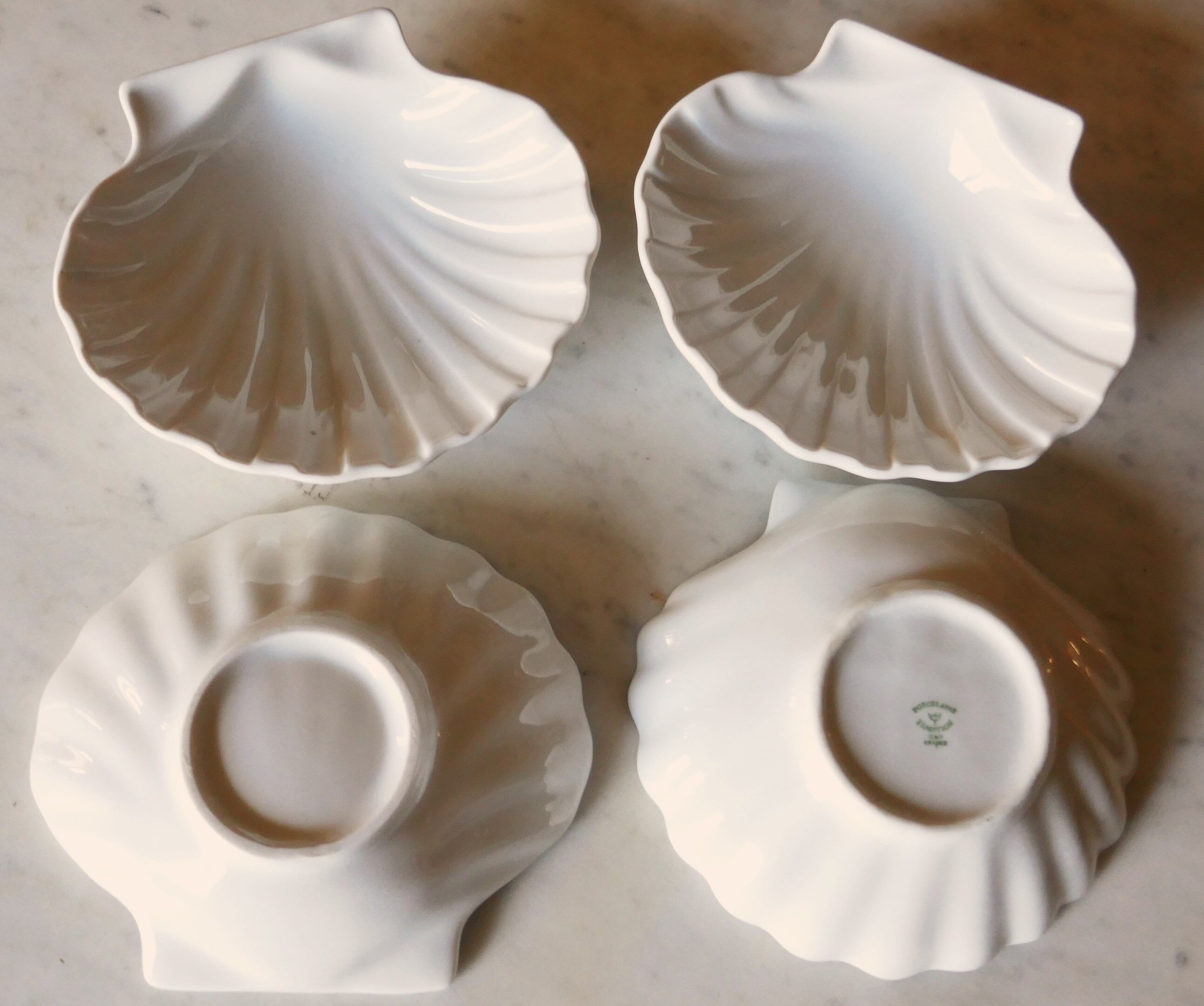 4 antique cups in the shape of a white porcelain shell