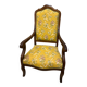 Louis XV style cabriolet armchair in solid wood, yellow floral fabric.