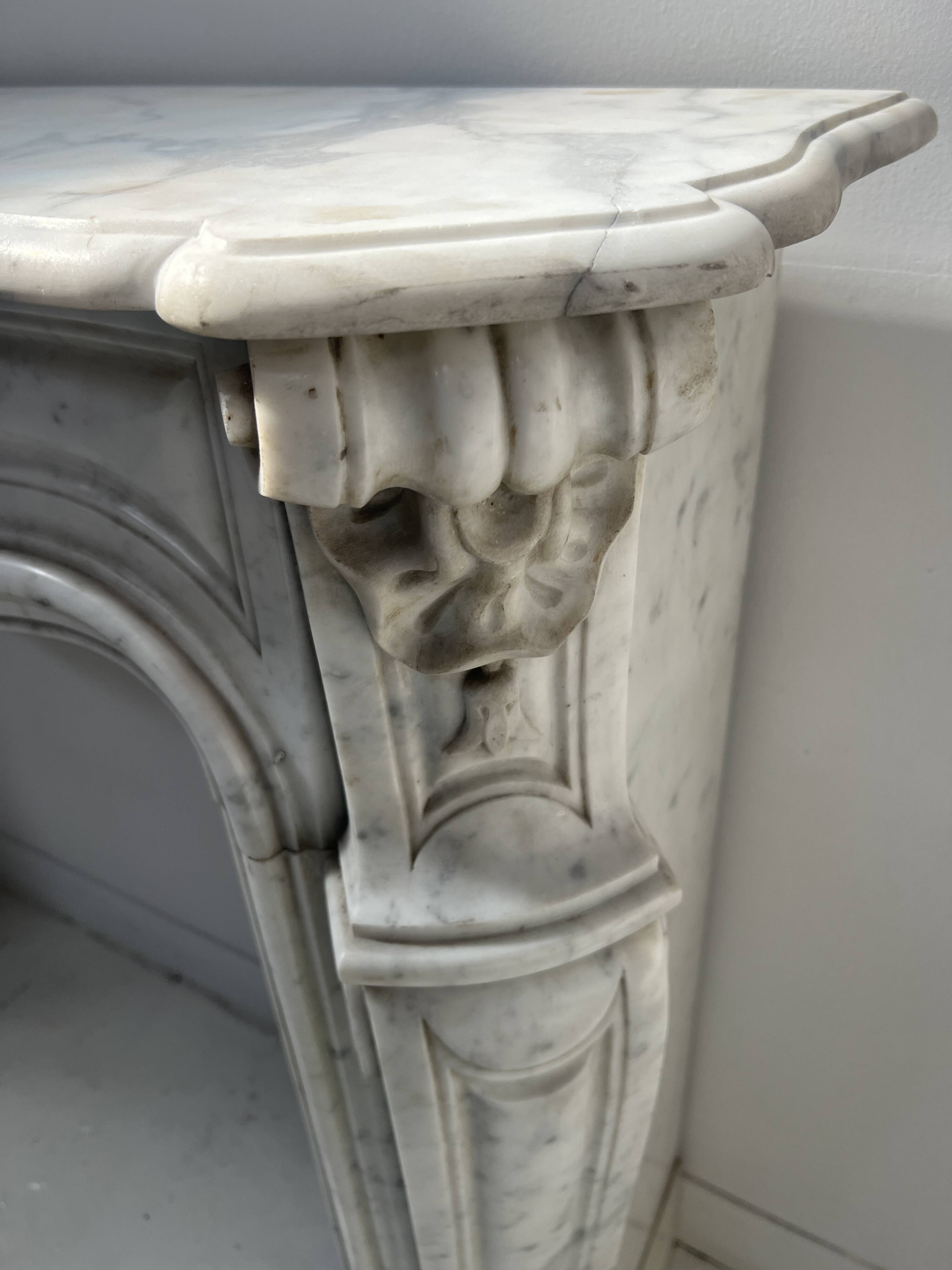 Louis XV style fireplace in veined white Carrara marble, 19th century.