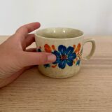 Speckled stoneware cup with blue flower