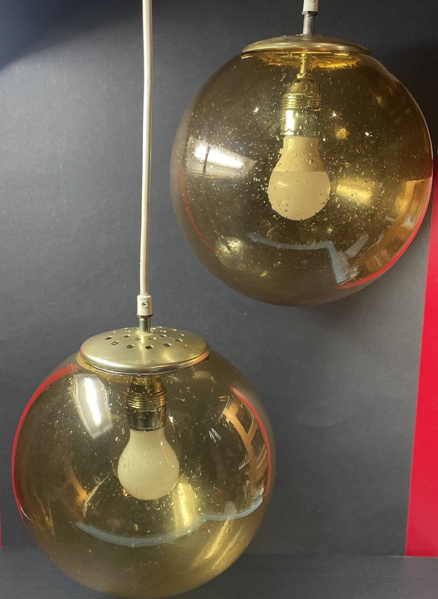 Pair of vintage smoked glass ball pendant lights from Biot glassworks