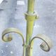 Antique green-painted iron floor lamp with a floral design.