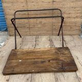 Folding workshop table with a metal frame and solid teak top.