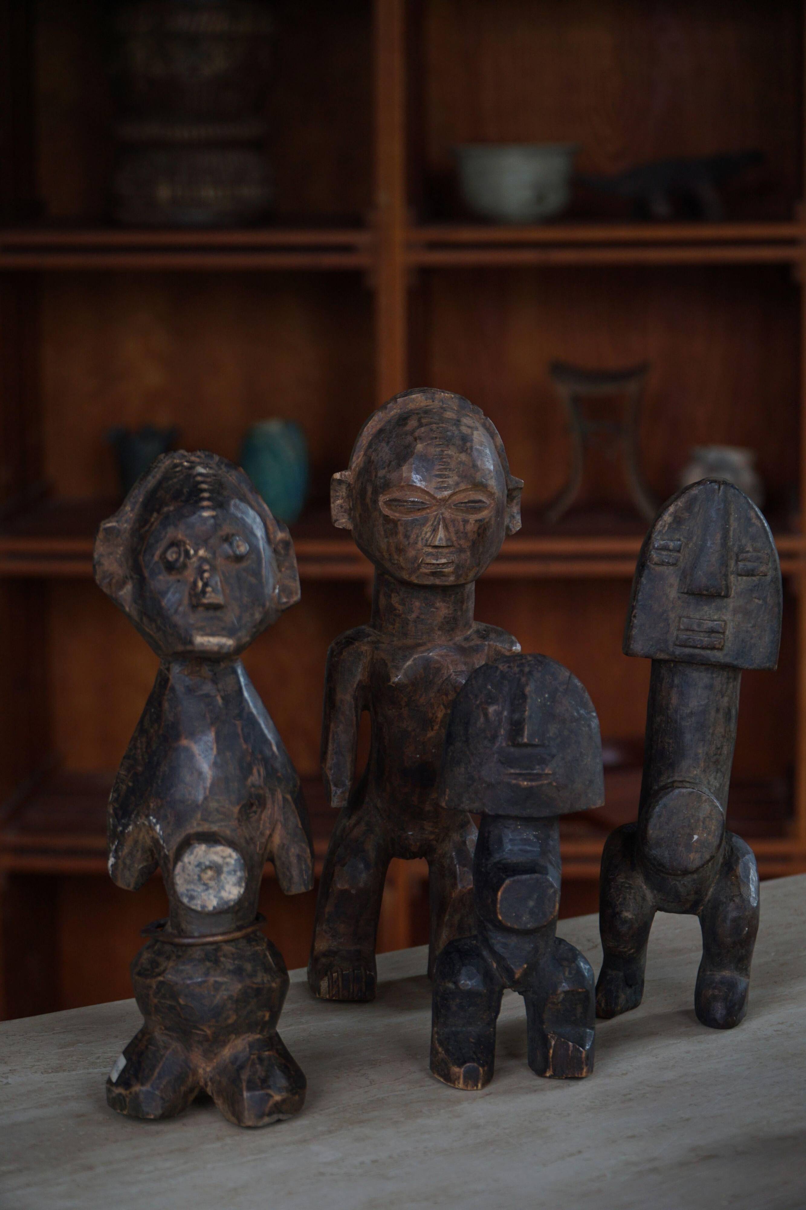 Set of 4 decorative handcrafted African wooden sculptures, mid-century.