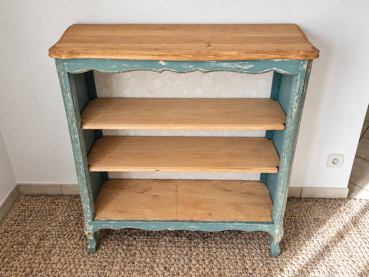 Antique wooden bookshelf with a patinated blue-green finish.
