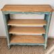 Antique wooden bookshelf with a patinated blue-green finish.