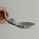 Soap dish, shell-shaped lightweight metal catchall.