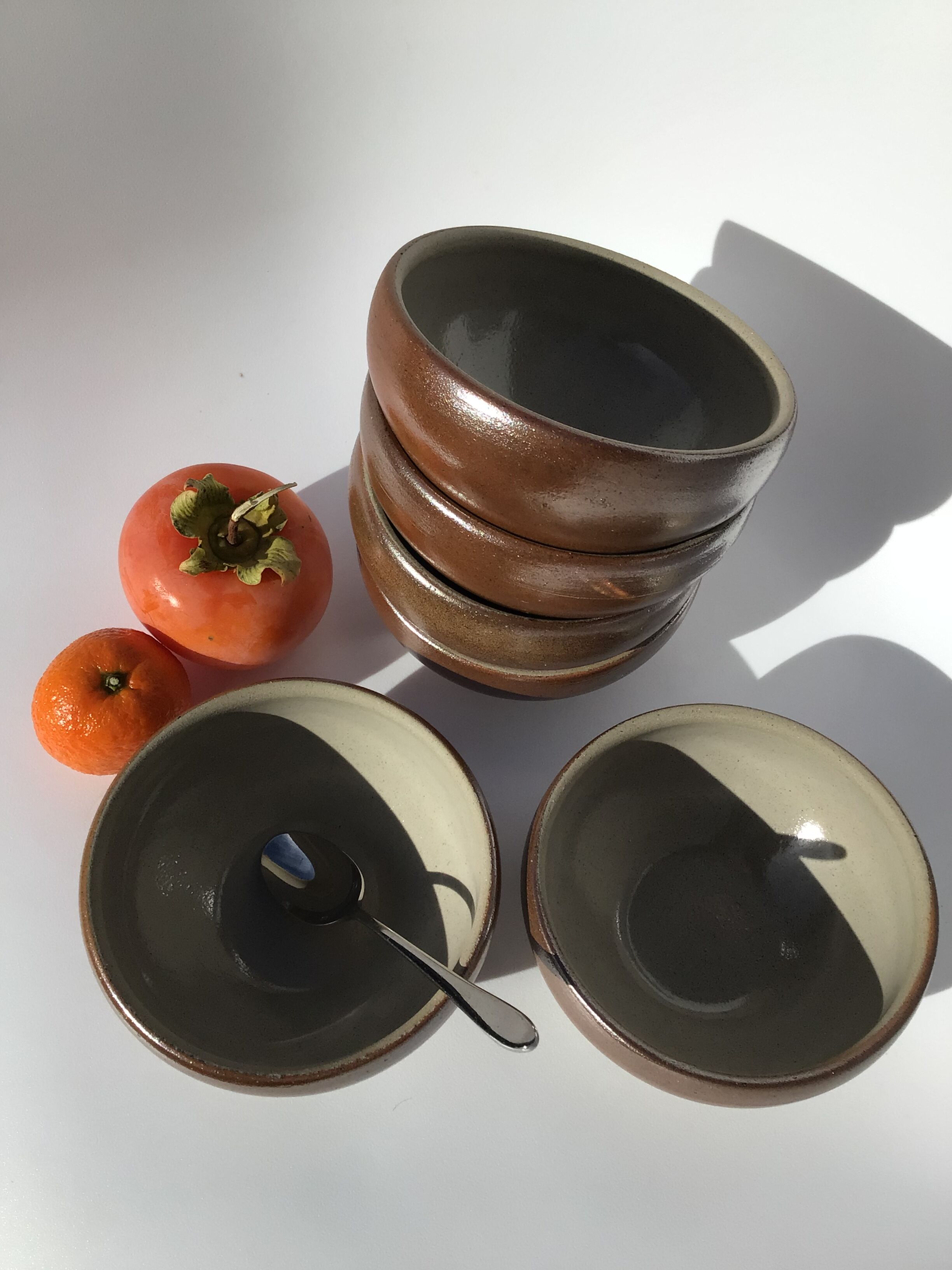 6 iridescent brown sandstone bowls inside grey