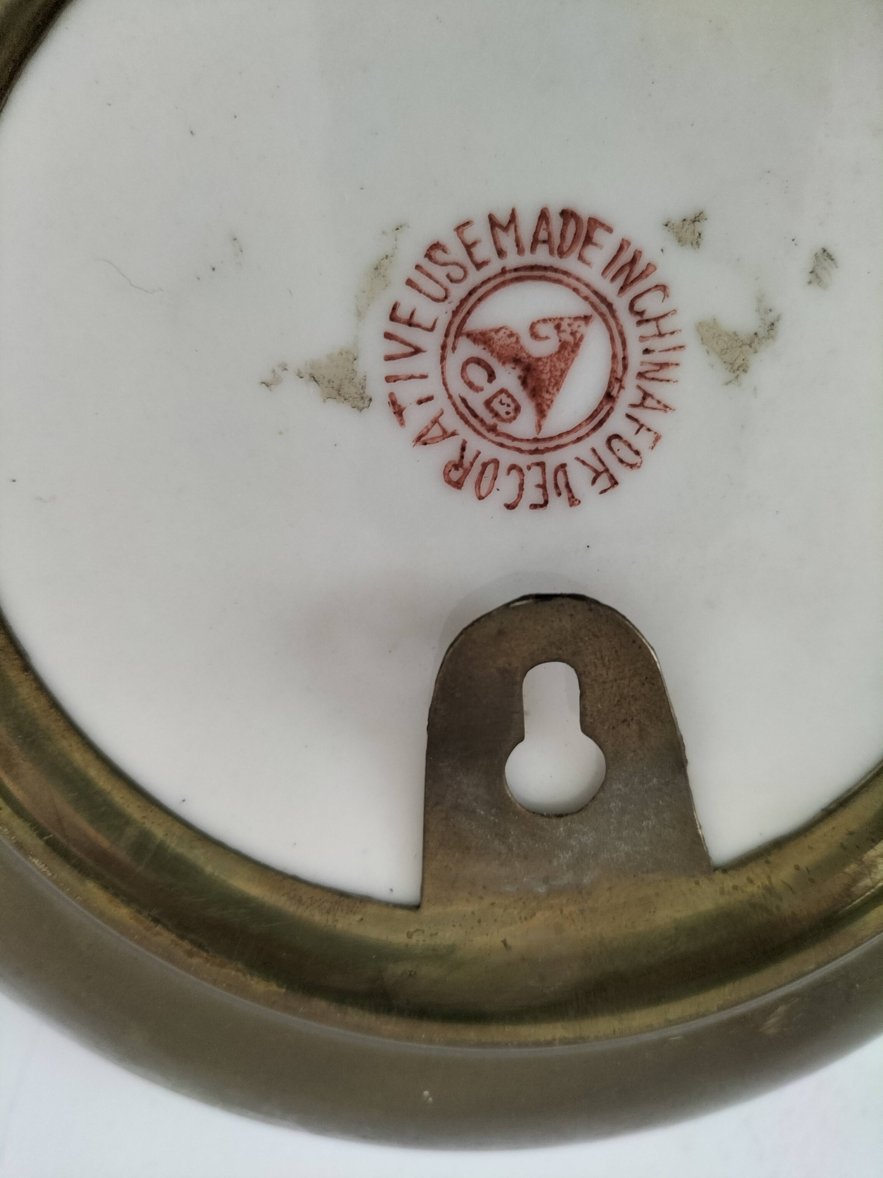 Pair of vintage Chinese decorative plates with floral decoration on a yellow background