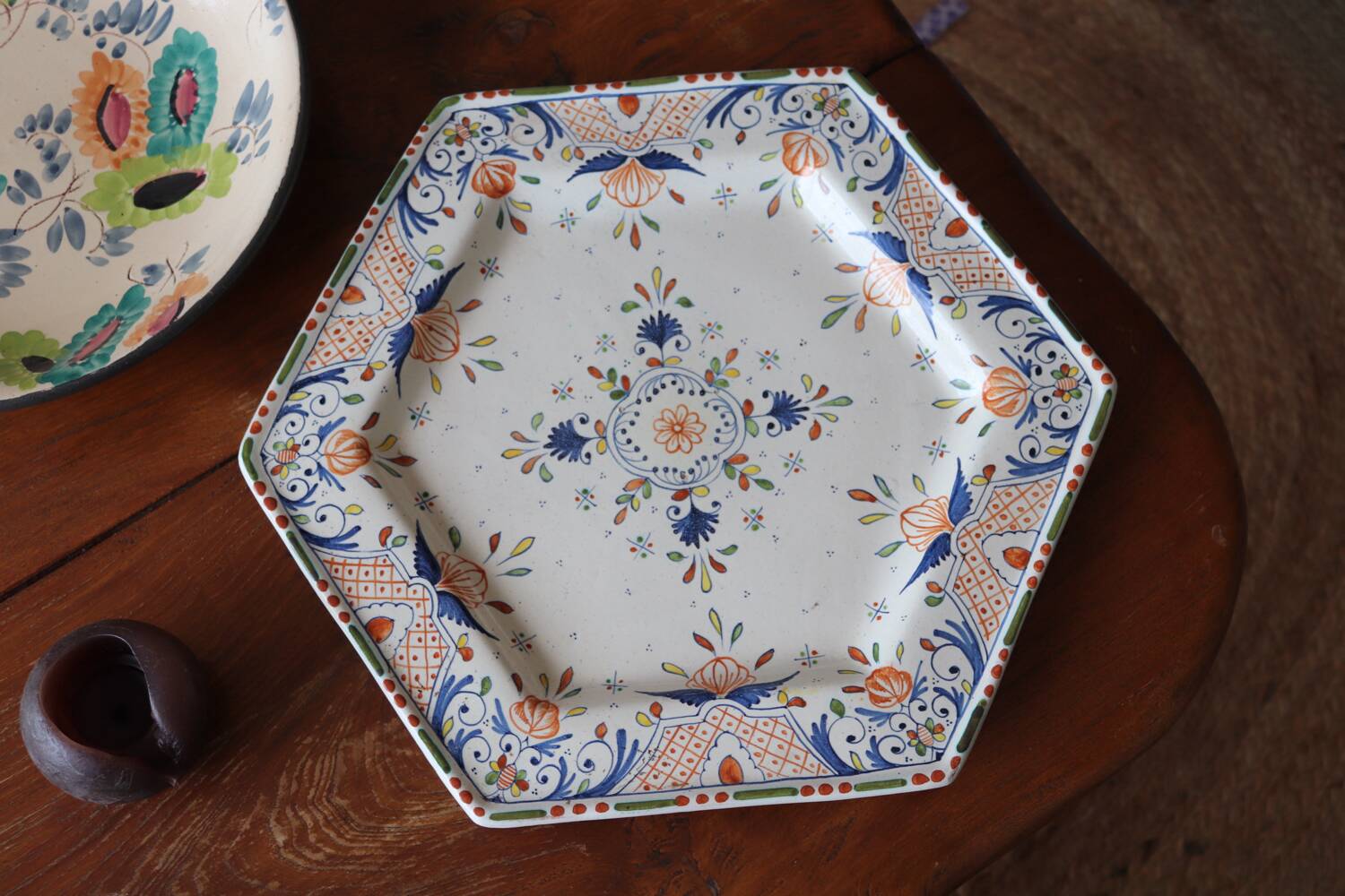 Ancient hexagonal plate in earthenware with polychrome floral decoration.