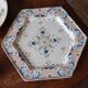 Ancient hexagonal plate in earthenware with polychrome floral decoration.