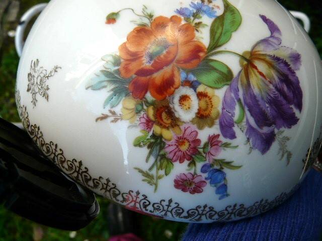 Art Nouveau wall light in bronze with a white Haviland porcelain shade.