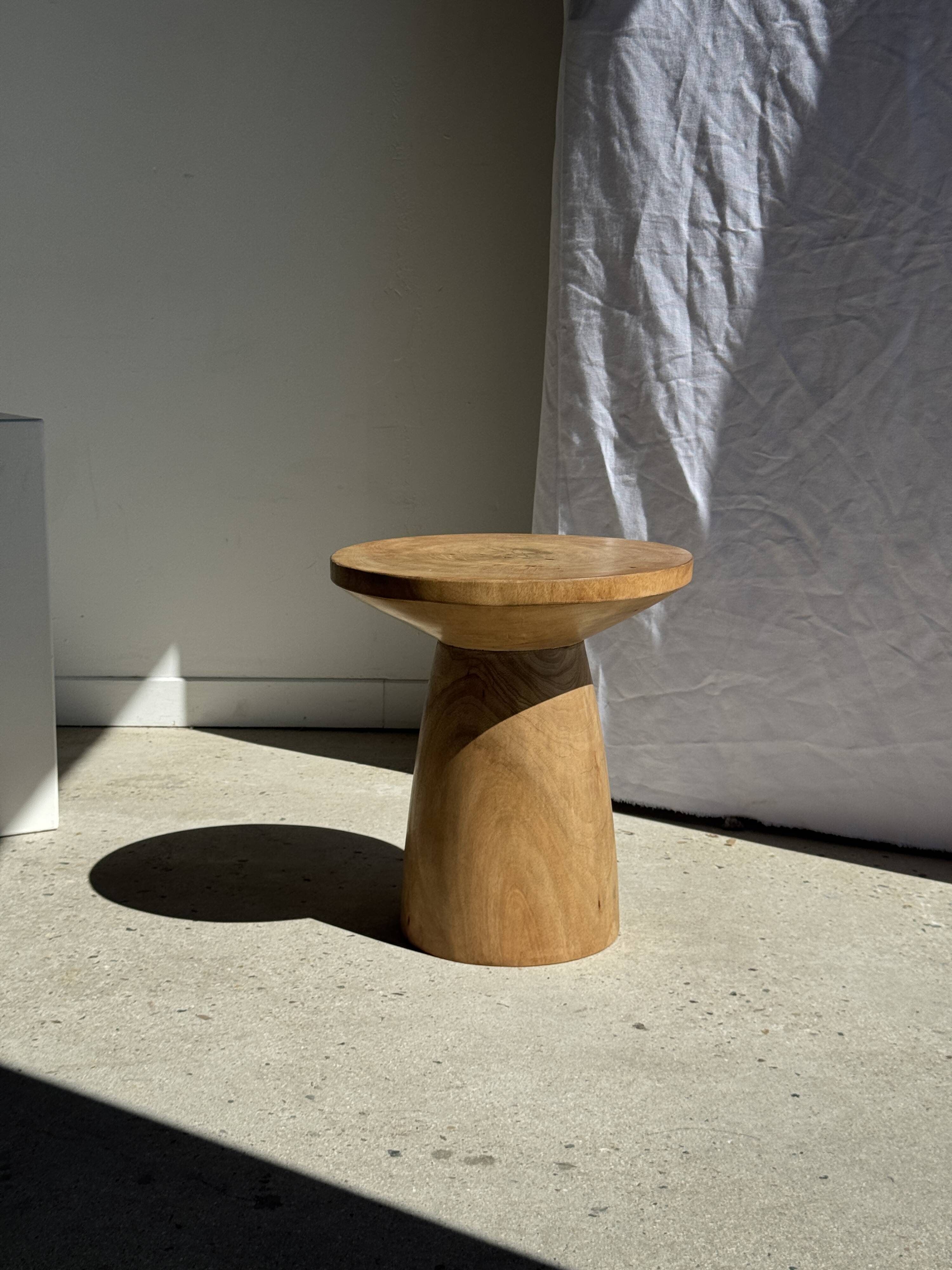 Natural solid mango side table (monoxyle) with conical legs.