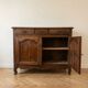 Old low sideboard in solid wood with drawers and doors.