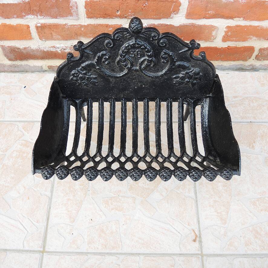 Old cast iron log cradle with backrest