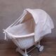 Wicker and painted wood baby cradle