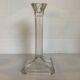 Four old square glass moulded candlesticks.
