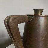 Modernist Italian pitcher design from the 1960s in patinated wood and metal.