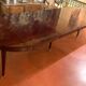 Directoire period extendable dining table in mahogany with a band.