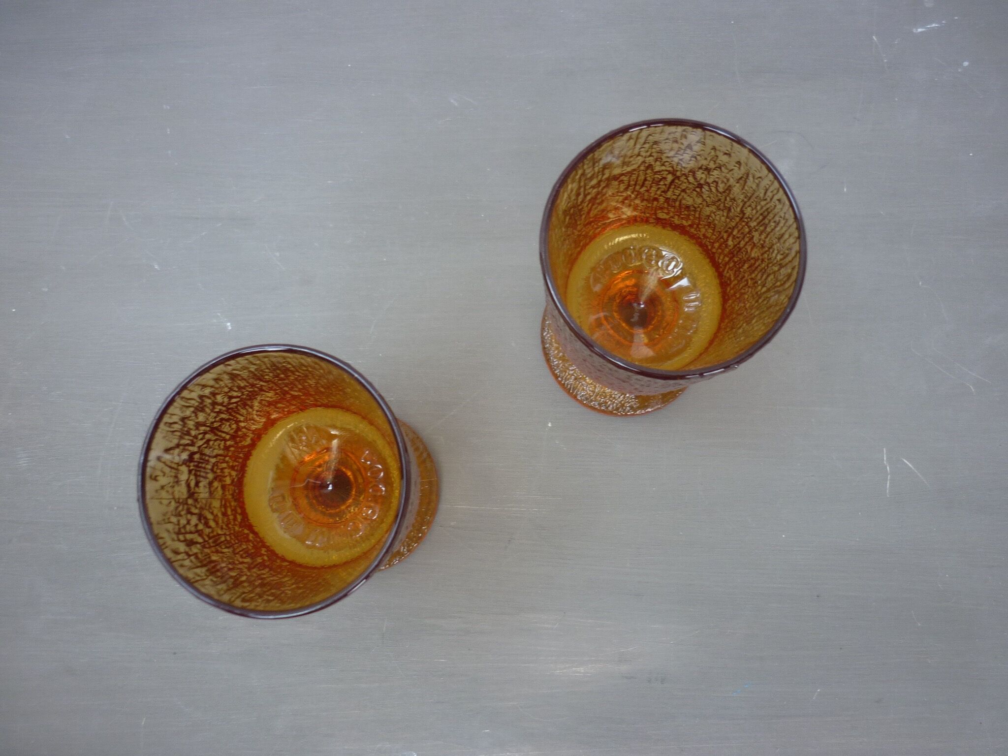 2 amber glass foot glasses