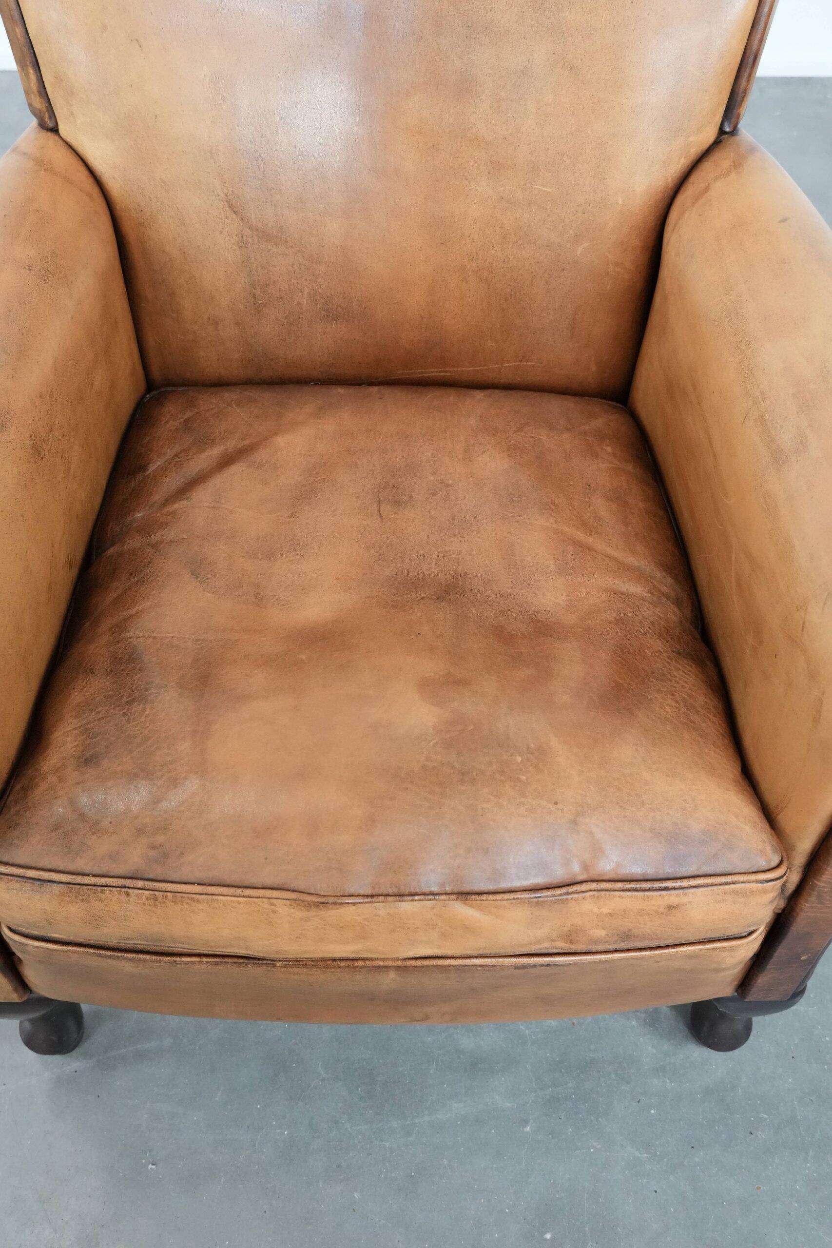 Vintage sheepskin armchair with a beautiful light colour and elegant legs