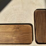 Trio of rounded rectangular trays or cups in monoxyl teak L:35