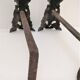 Pair of bronze andirons with black patina, 19th century, female caryatids