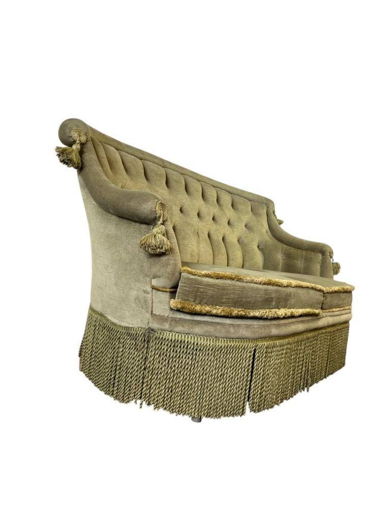 Vintage green two-seater sofa with fringes