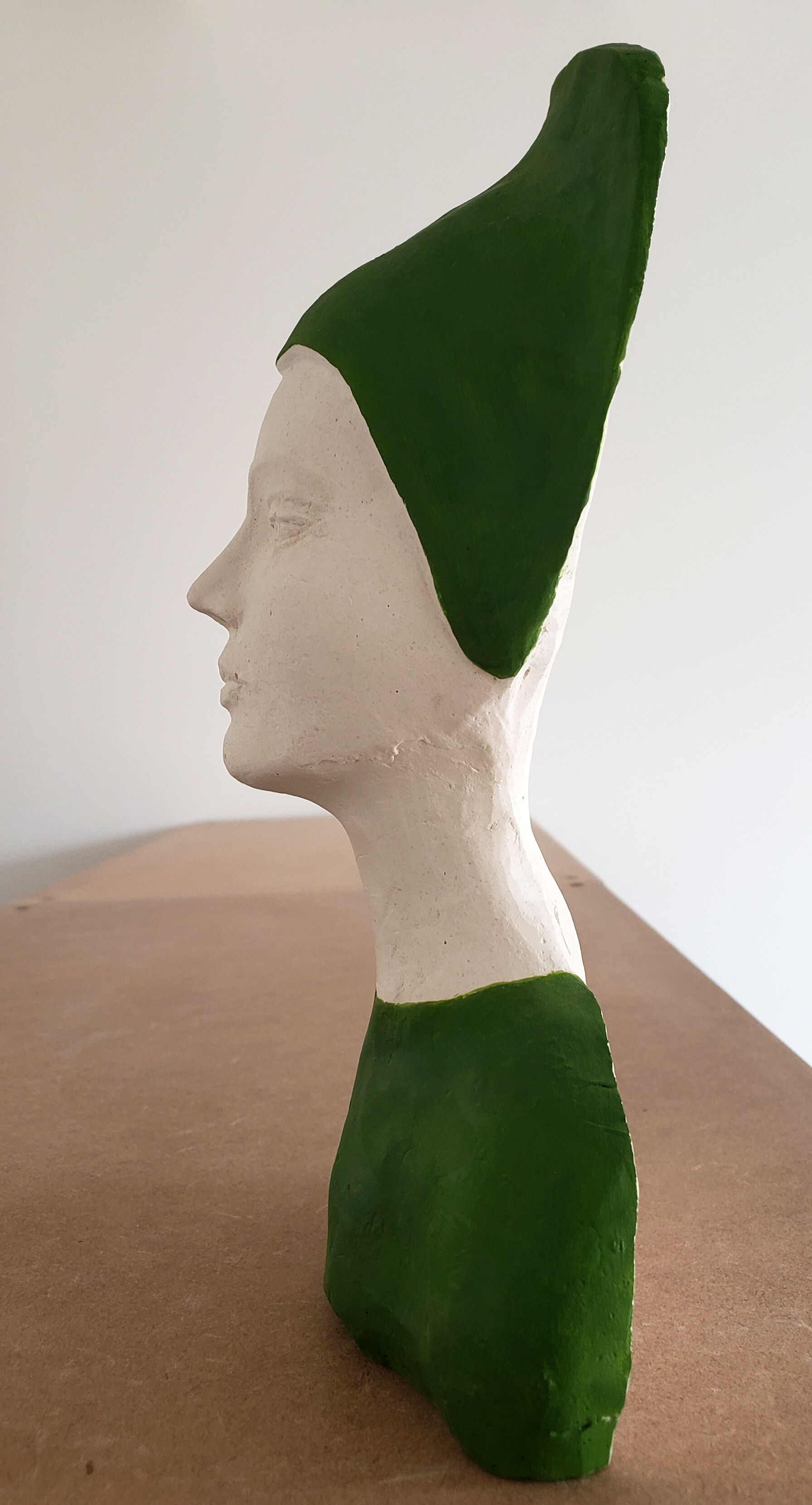 Bust of a woman in green and white plaster