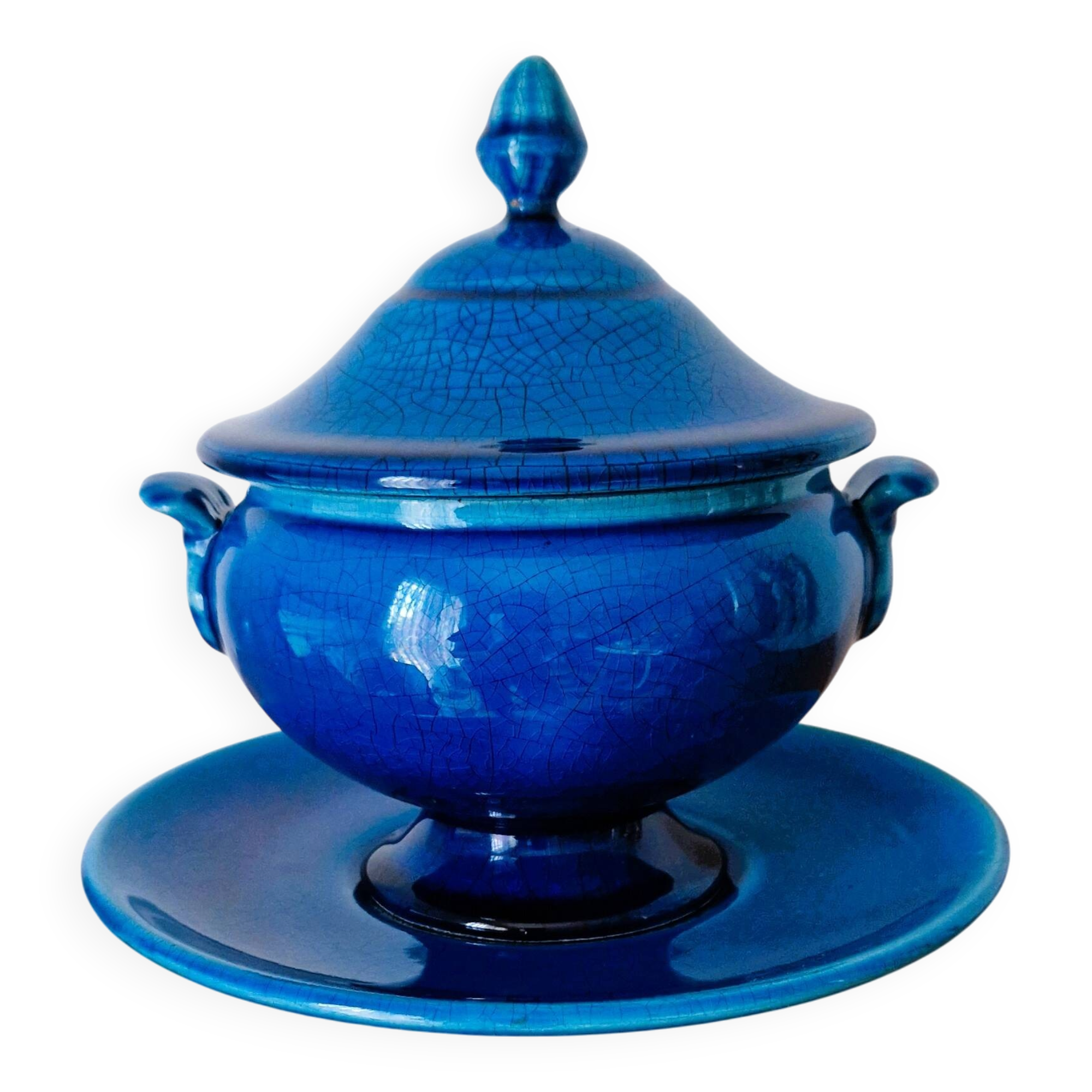 Blue ceramic soup tureen and crackled finish trivet.