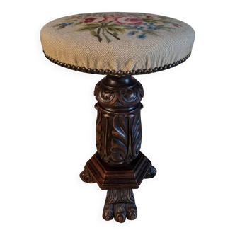 Antique wooden piano stool, adjustable with a sculpted base and upholstered seat, circa 1880–1910.