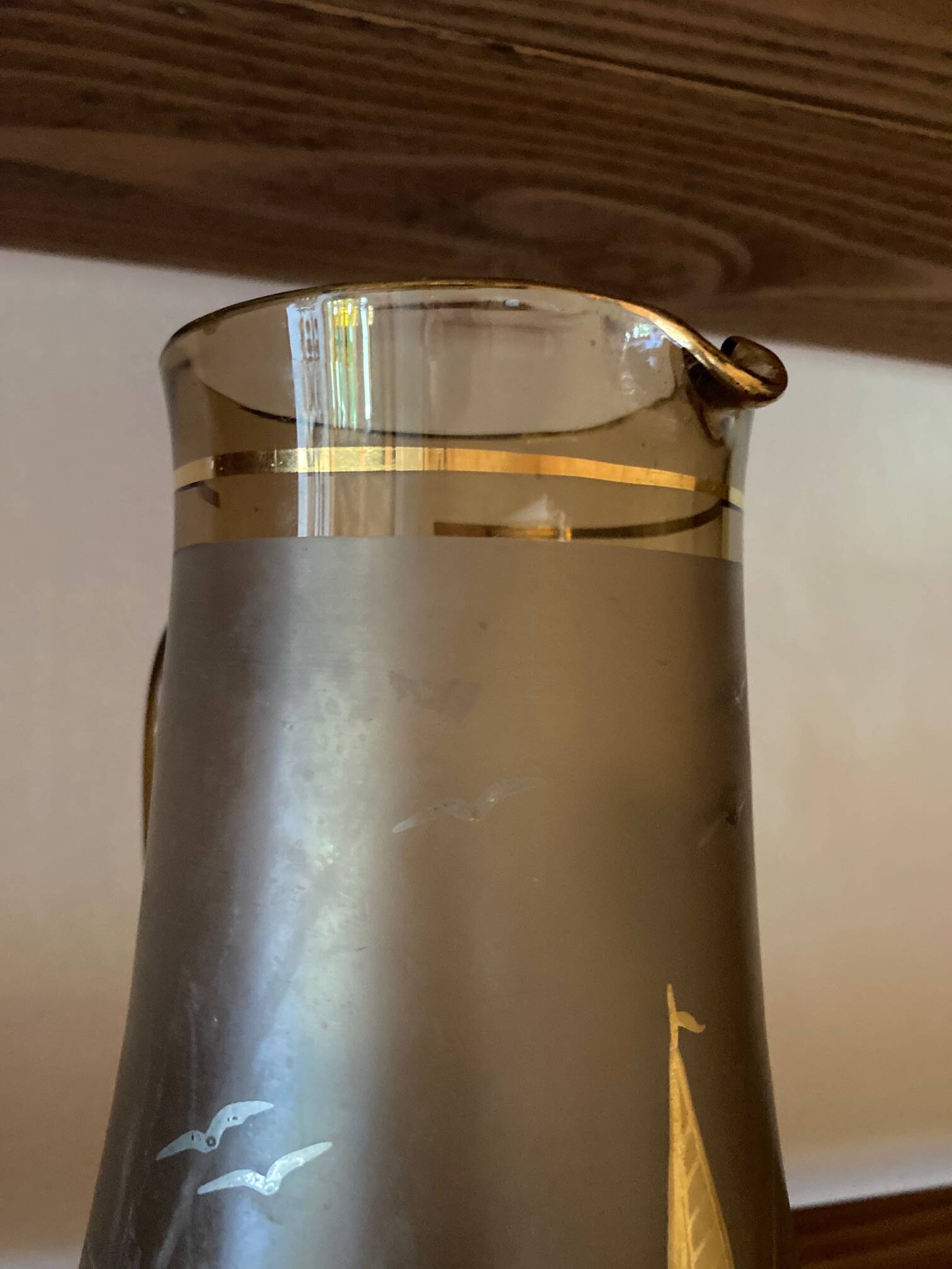 Vintage smoked glass carafe with gold from the 50s/60s, featuring a marine and water skiing design.