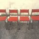 Set of 4 vintage chrome and orange faux leather chairs.