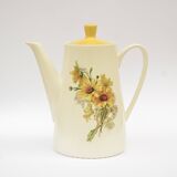 Old glazed ceramic coffee pot decorated with sunflowers
