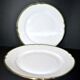 2 plats ronds chantournés anciens en porcelaine liseré or vert "aux lions de faïence paris", limoges