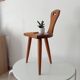 Low brutalist tripod chair in solid oak from the 1960s.
