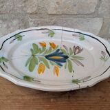 Old oval dish with floral motif called black bottom with staples