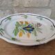 Old oval dish with floral motif called black bottom with staples