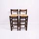 Set of 2 vintage wooden bar stools with woven straw seats.