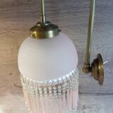 Brass swan neck wall lamp with pink glass globe and Charleston tassels