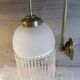 Brass swan neck wall lamp with pink glass globe and Charleston tassels